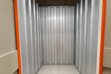 Clean and empty small self-storage unit with metal interior at EBC Lifestyle Hub Singapore.